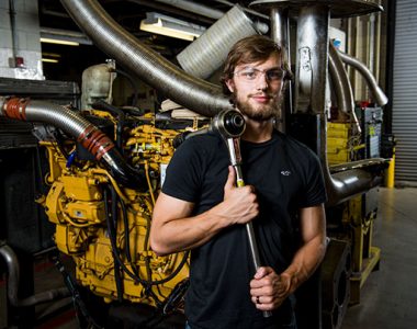 Person holding mechanical tool at industrial building in Somerset-Pulaski County, Kentucky