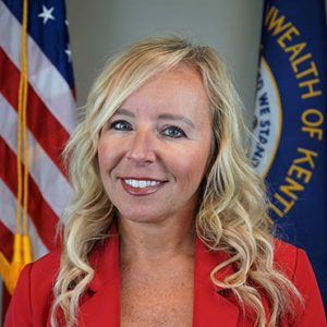 woman in front of American and Kentucky flags