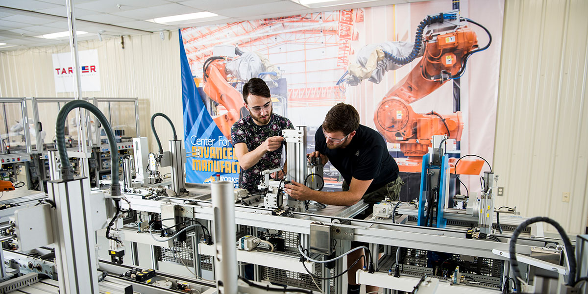 Two men working on advanced manufacturing robotic installment, Somerset-Pulaski County, KY