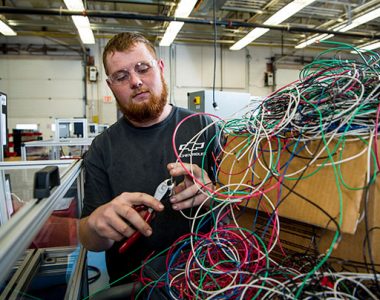 Person cutting wire a industrial factory, Somerset-Pulaski County, Kentucky