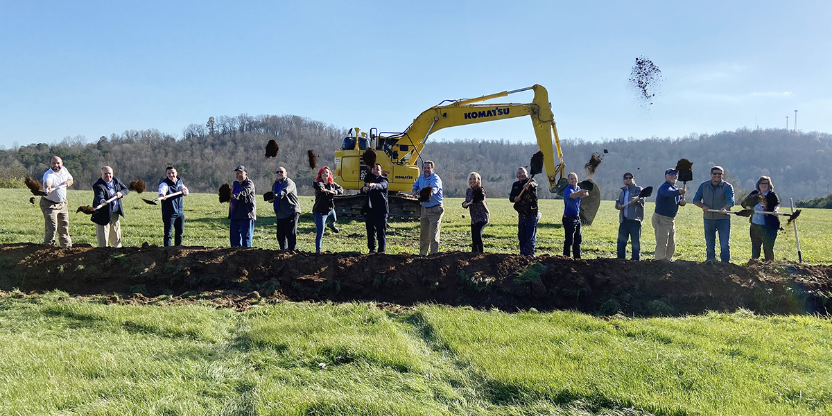 people shoveling dirt into the air