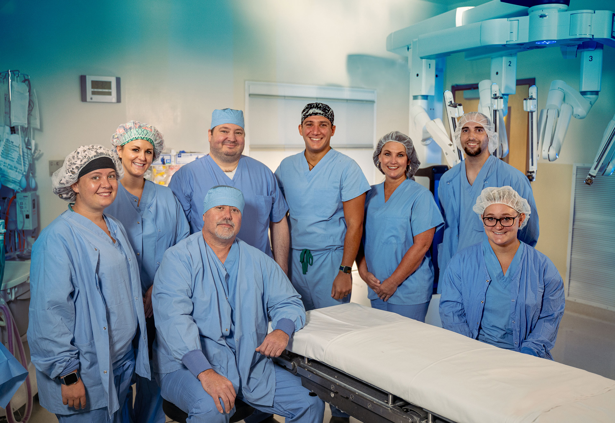 group of doctors and nurses standing in operating room