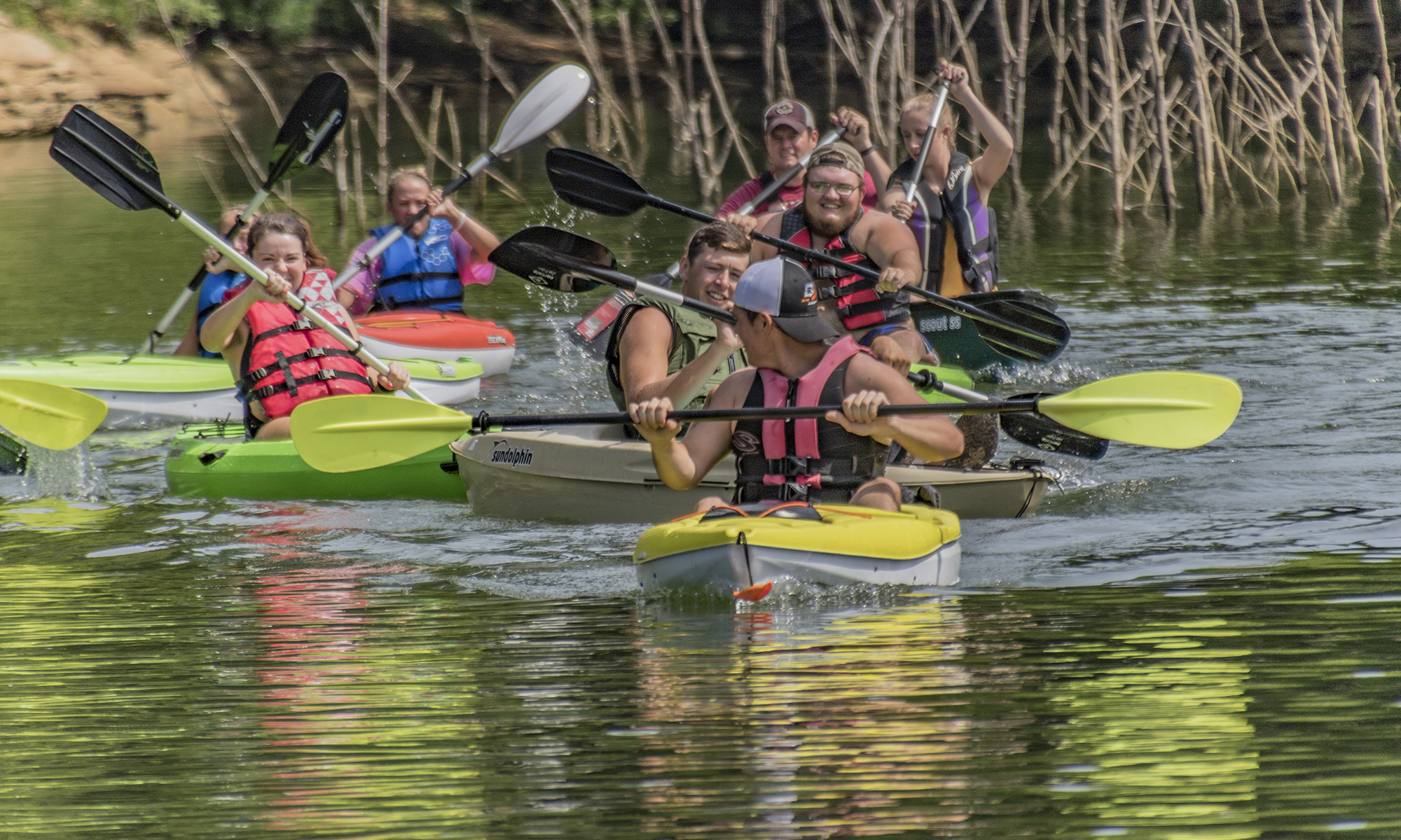 group of men and women kayaking